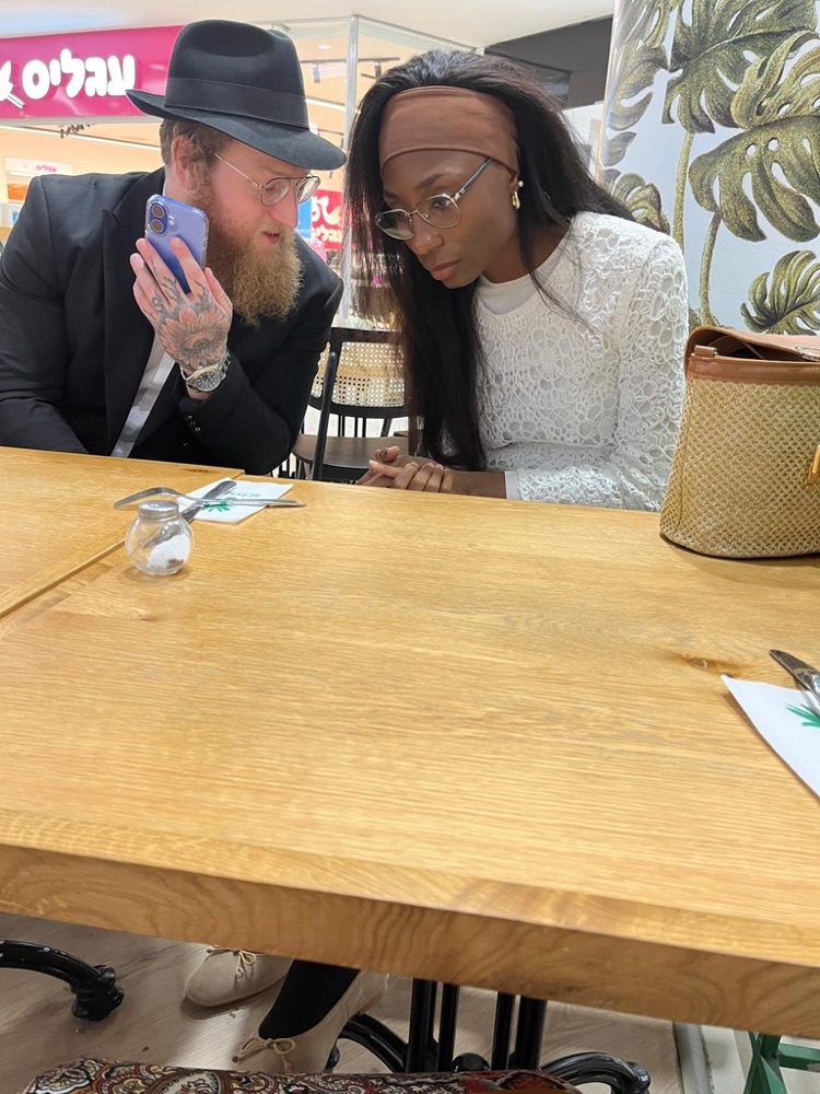 A shared moment of conversation over a table in Hadera