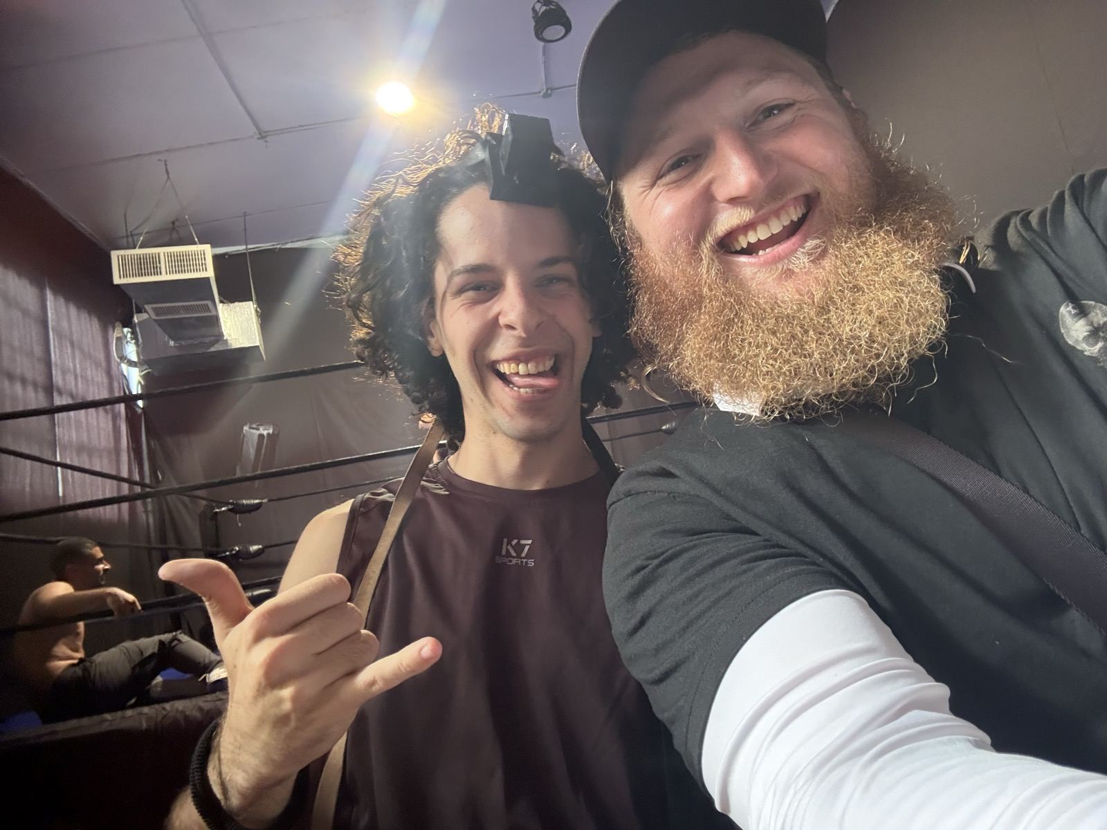 A rabbi and a young man taking a selfie in a gym