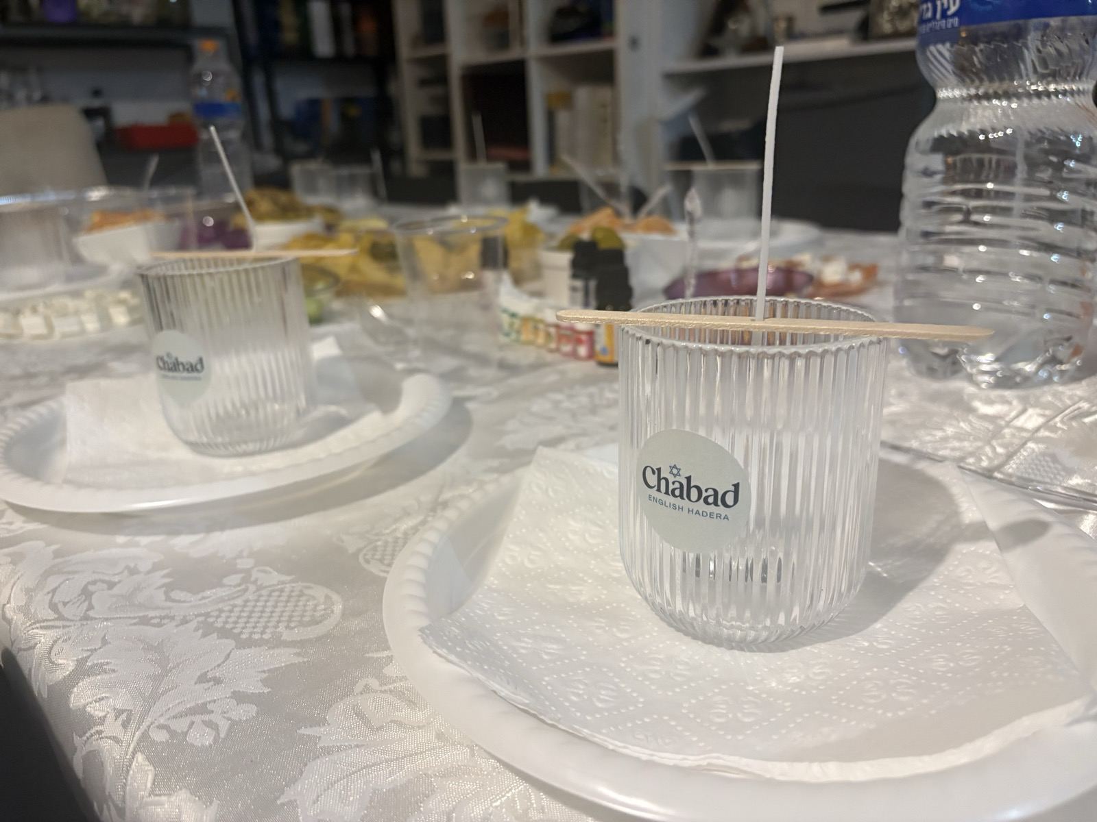 A festive table set with Chabad cups, ready for guests